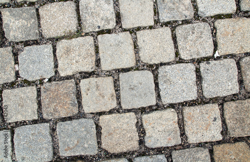 old style cobblestone pavement of grey granite stones