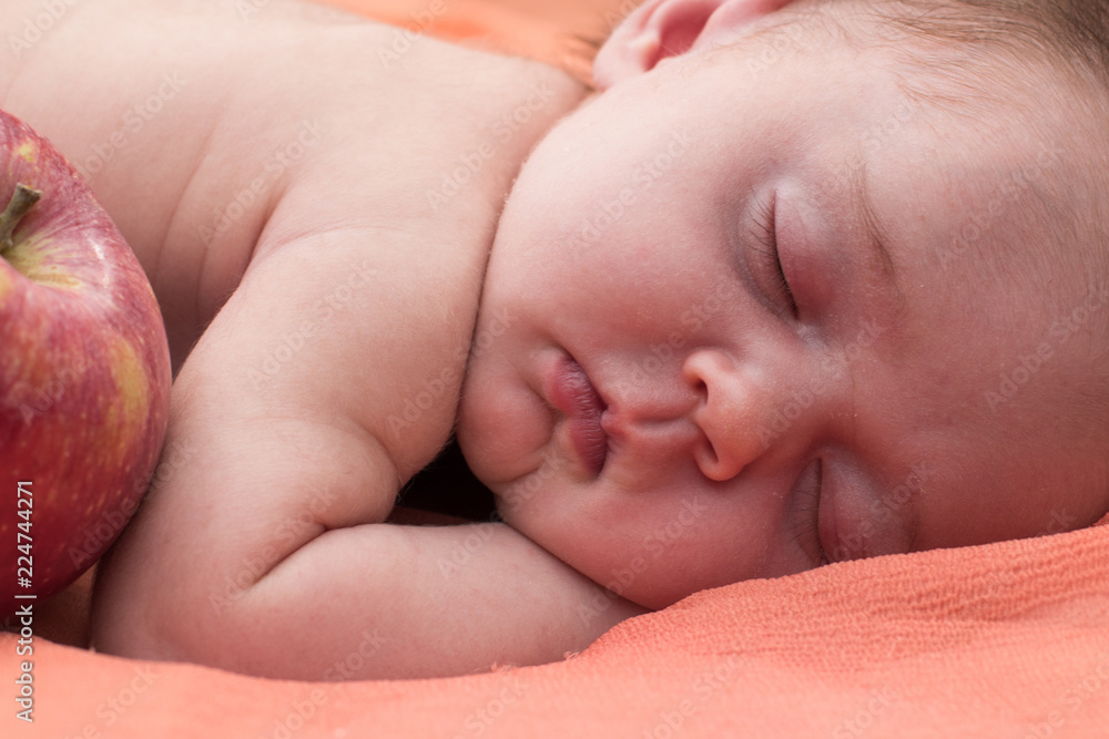 a newborn sleeps on a coverlet a newborn sleeps on a coverlet