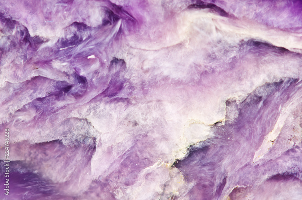 Lilac background. Charoite. Mineral. Crystal. Natural abstract b