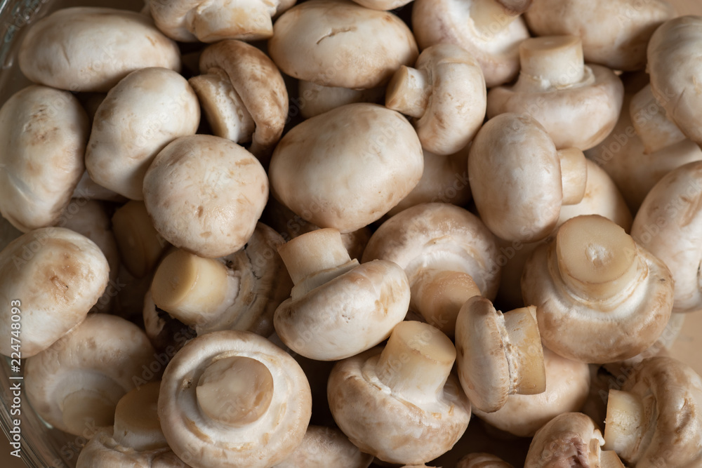 closeup of raw washed mushrooms - champignons, ready for later cooking. vegetarian menu. closeup of raw washed mushrooms - champignons, ready for later cooking. vegetarian menu.