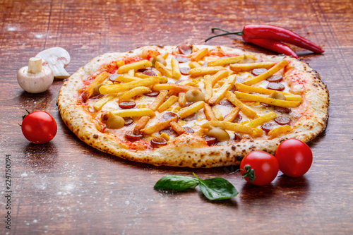 Pizza with french fries and sausage. Appetizing pizza with cheese and potatoes photo