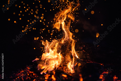 Fiery fire isolated on black isolated background . Beautiful yellow, orange and red fire flame texture style.