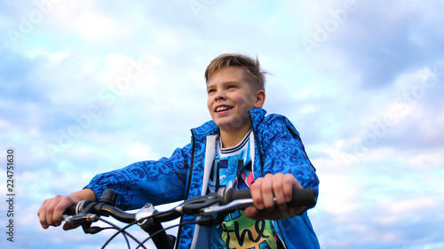 Teenager riding a bike, doing sports in the fresh air. Travel and active entertainment. Moments of happy childhood