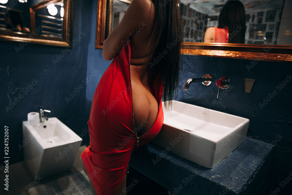 Sexy girl in red dress.A girl with a beautiful booty.Girl in the bathroom  dresses Stock Photo | Adobe Stock