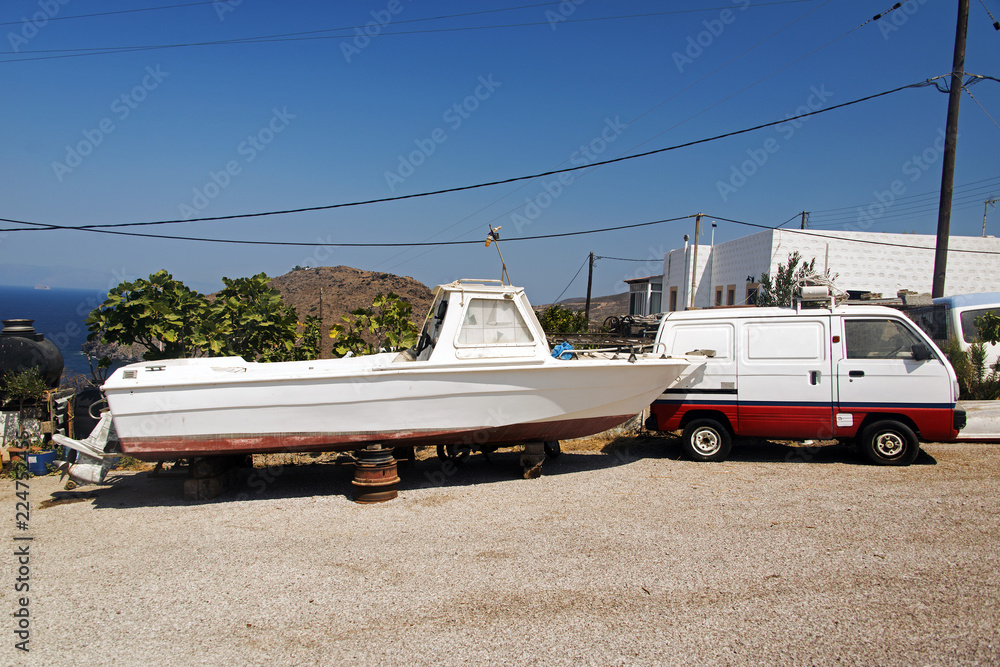 Φωτογραφία A motor boat and a vintage car in a shipyard in island of Patmos, Greece