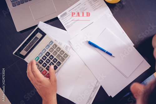 budget planning -Man writing home budget with calculator top view.