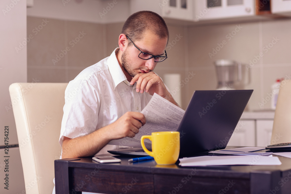 man working on laptop at home office. man working on laptop at home office.