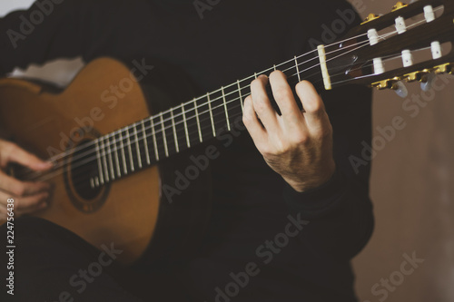 Closeup hands playing classical guitar