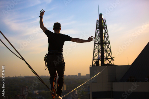 Slackliner balancing on highline photo