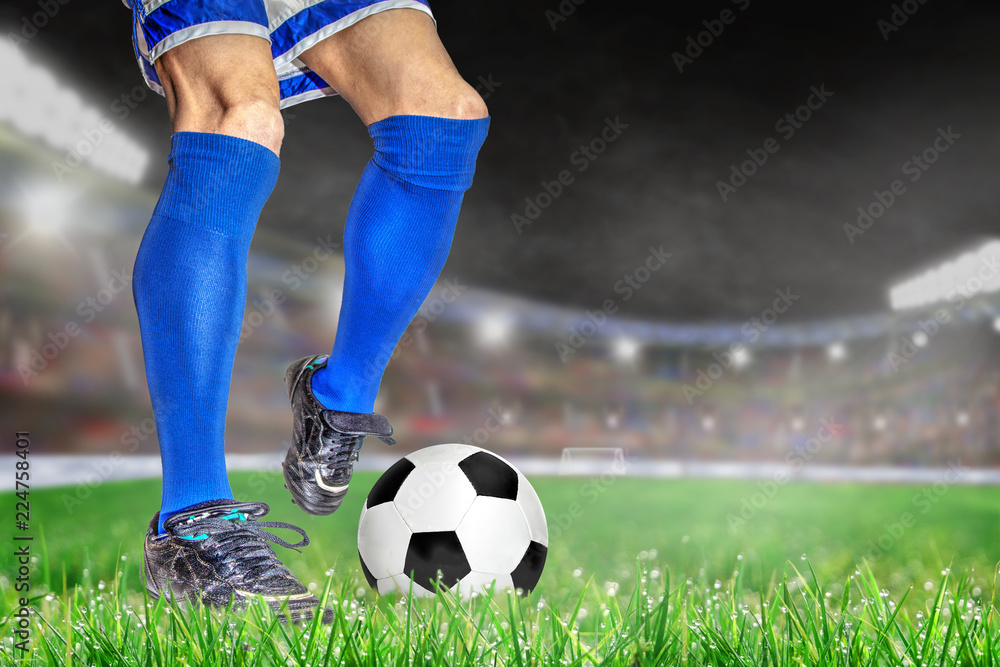Soccer Player Kicking Football in Outdoor Stadium With Copy Space