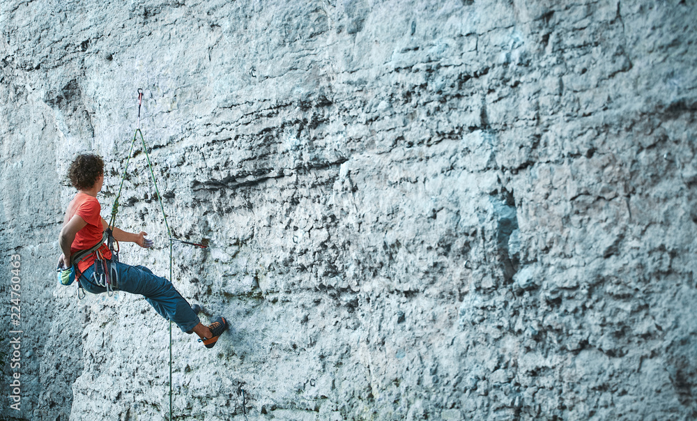 man rock climber climbing on the cliff