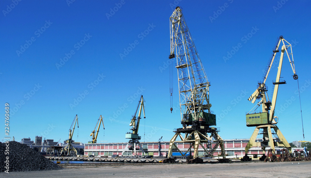 Cranes on the keys in the port with blue sky