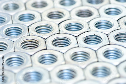 Fasteners on a white background. Manufacture of metal products.