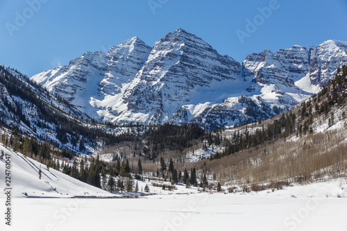 Colorado Matroon Bells Tocky Mountains snow covered mountains on a blue sky day