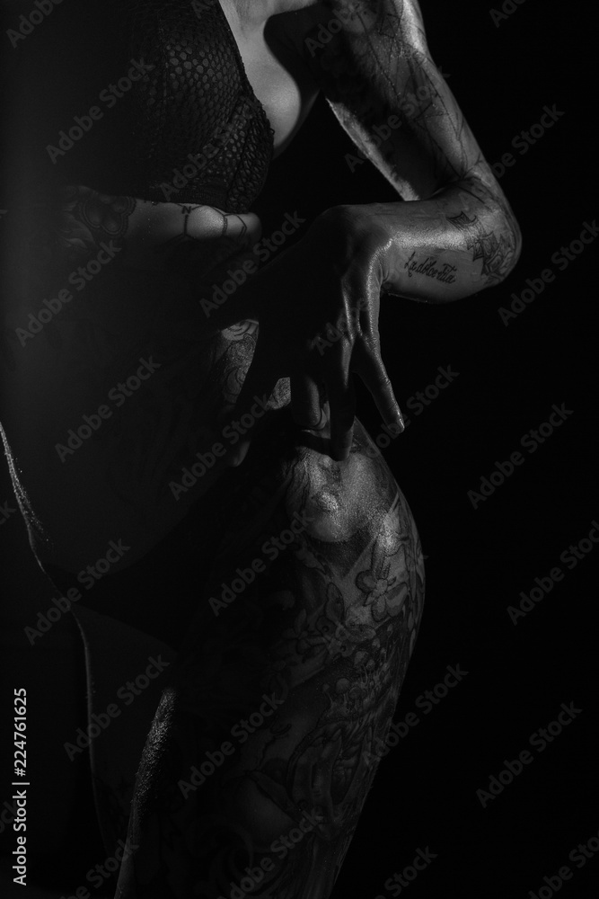 Monochrome bodyscapes of a fit tattooed woman Monochrome bodyscapes of a fit tattooed woman