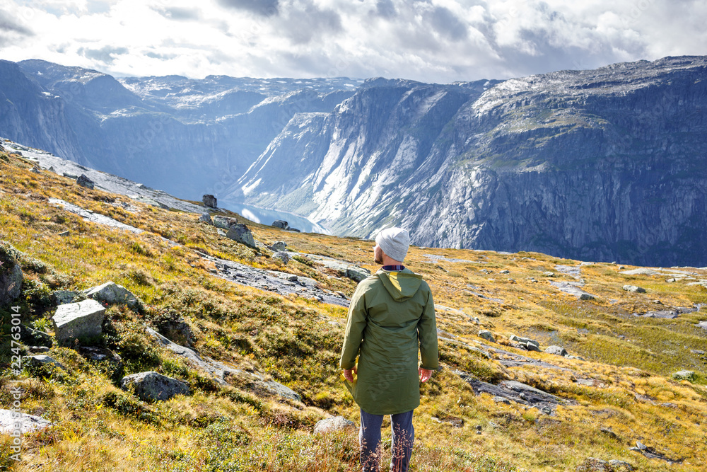 Man stands before the gorgeous view at Norway mountains