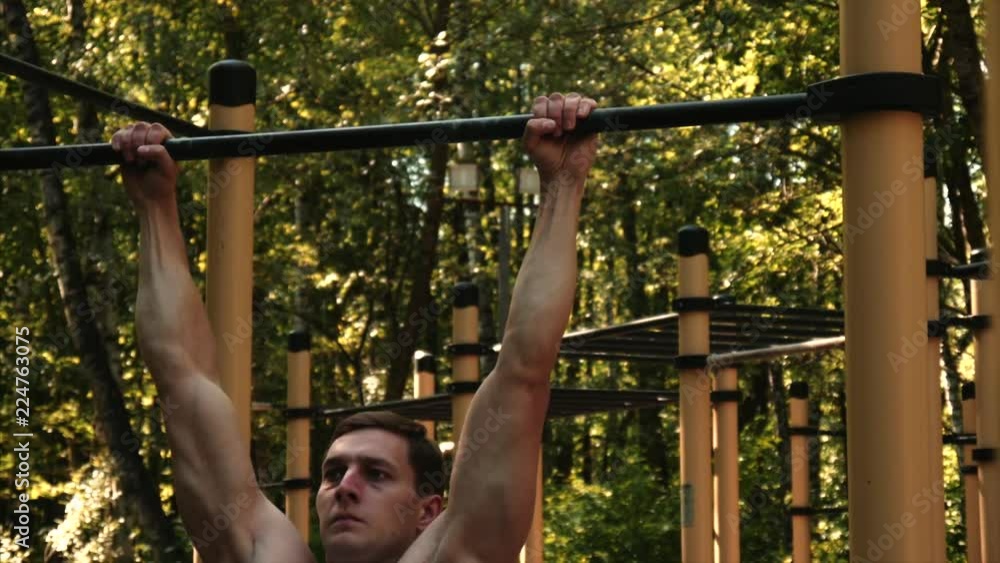 Man do pull ups at park. Street workout. Medium shot. Man do pull ups at park. Street workout. Medium shot.