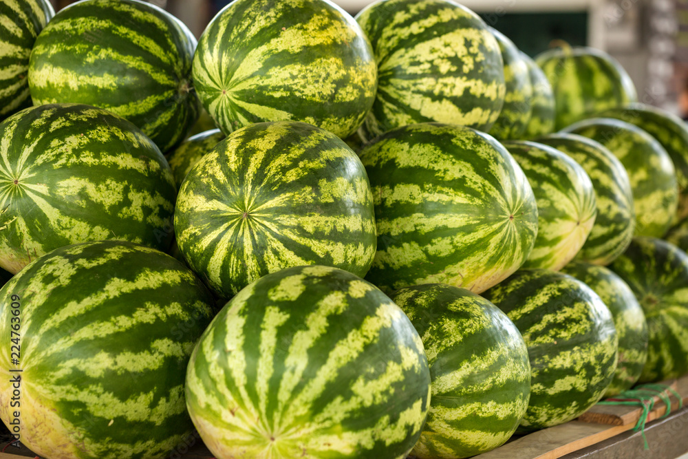large green watermelons are on the market