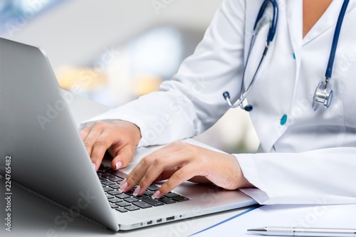 Close-up Doctor at hospital working with laptop