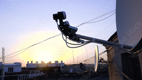 TV aerial antennas on the roof top during sunset