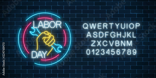 Glowing neon labor day sign in circle frames with alphabet. World labor day symbol with wrench in hand