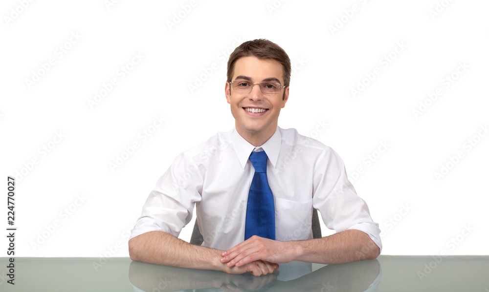 Smiling Businessman Sitting at the Desk with Glasses Smiling Businessman Sitting at the Desk with Glasses