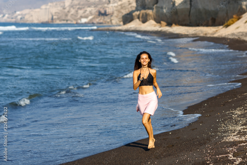 Beautiful brunette girl running in the beach at summer vacations Beautiful brunette girl running in the beach at summer vacations