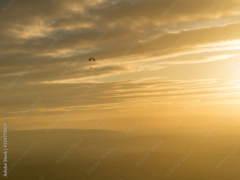 Motor trike hang glider flying in the sunset Malvern hills Worcestershire