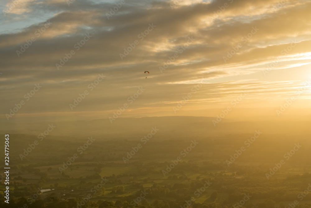 Motor trike hang glider flying in the sunset Malvern hills Worcestershire Motor trike hang glider flying in the sunset Malvern hills Worcestershire