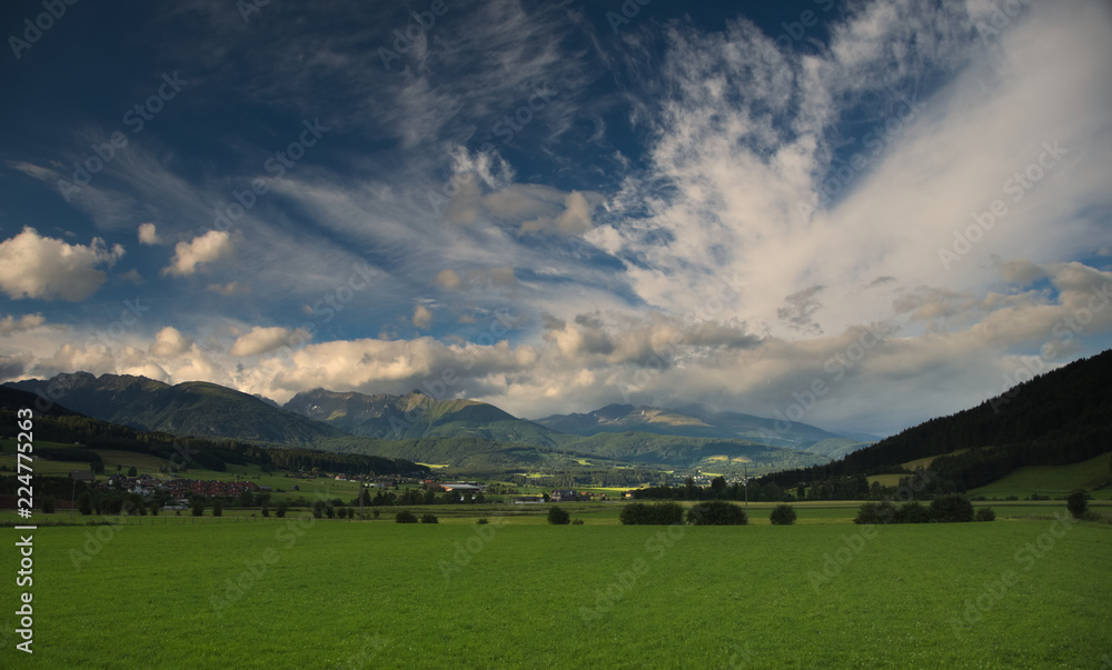 A beautiful view at meadows, hills and mountains during sunset near Mautendorf village, Austria.