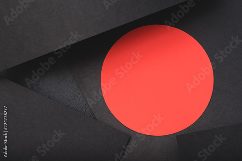 paper layers. contrast of black sheets and red circle. minimalistic abstract background with copyspace.