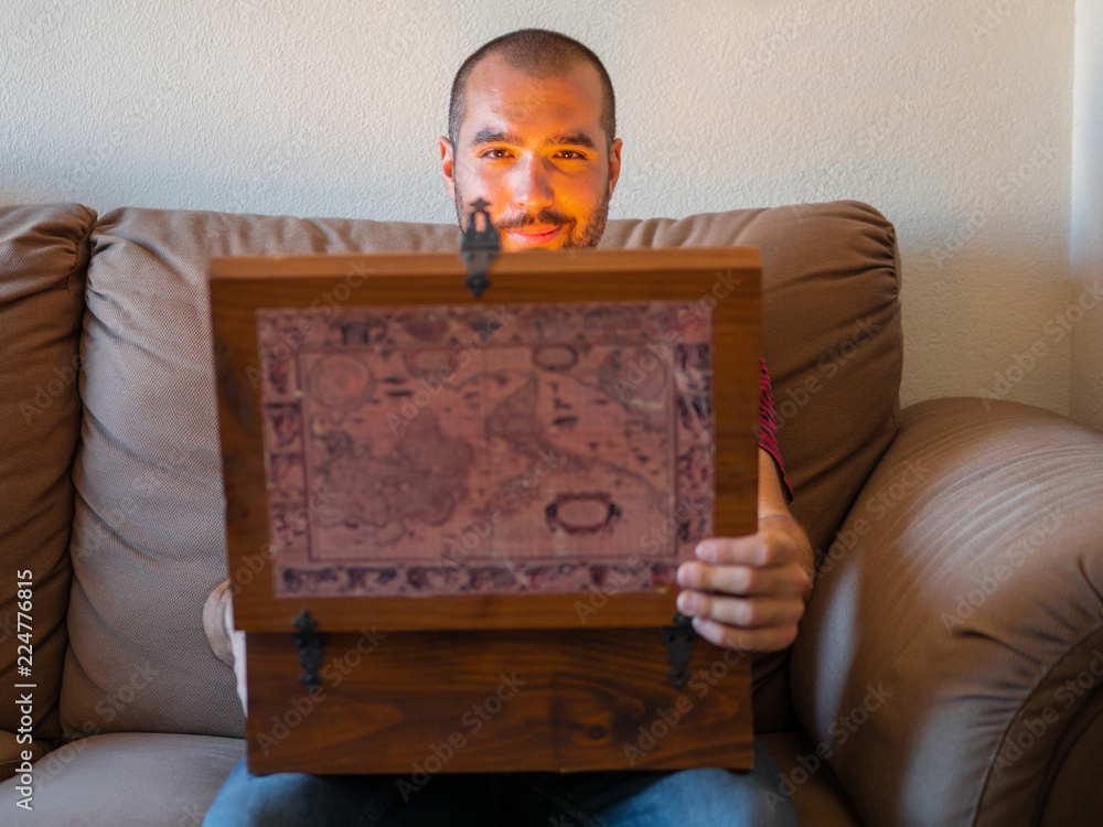 Fototapeta premium Man smiling with a open treasure chest with gold inside