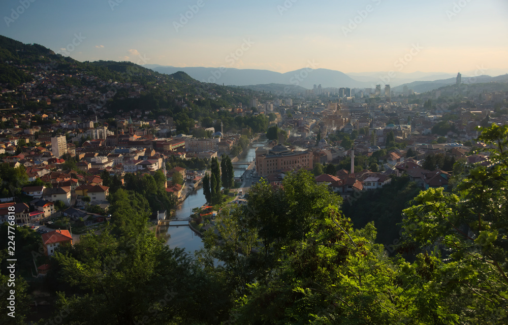 Overlooking city center of Sarajevo from a nearby hill during sunset. 