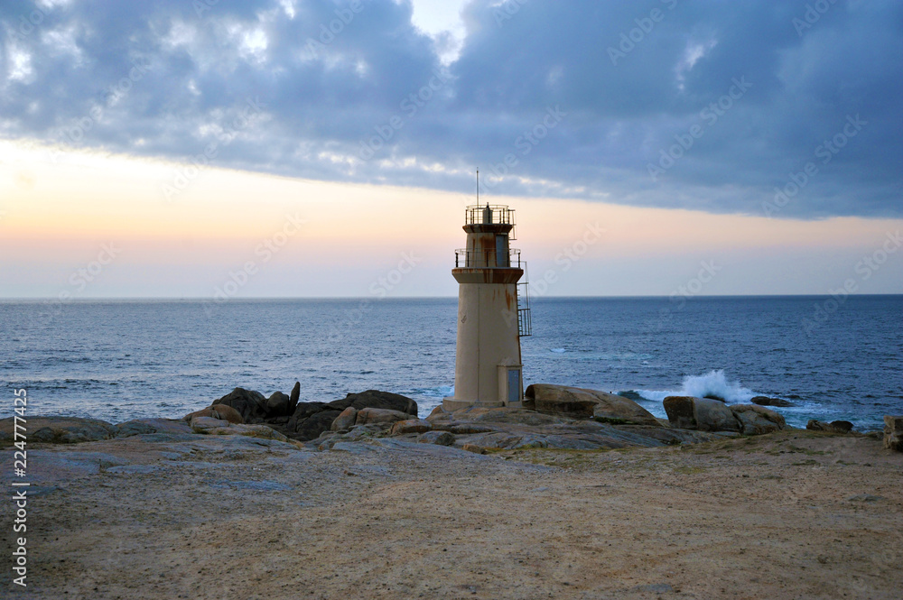 Lighthouse of Muxia, Galicia, Spain - July 18, 2018: Lighthouse de la Barca, at the en of the Way of St. James, Camino de Santiago de Compostela