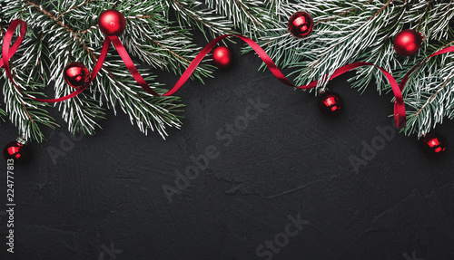 Wallpaper Mural Horizontal black stone background with fir branches decorated with red balls. Top view. Space for text Torontodigital.ca