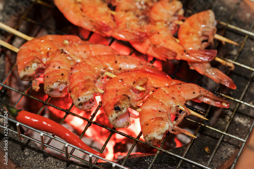 Fresh shrimps on hot coals barbecue outdoors