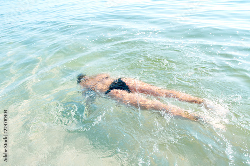 Young woman swimming underwater in sea