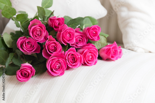 Heap of perfect pink roses on a white sofa couch