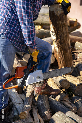 The worker works with a chainsaw. Chainsaw close-up.