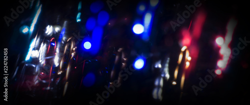 Neon sparks on a dark background. Neon light, laser. Blurred background. Abstract dark festive background.
