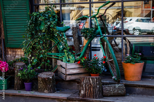 Showcase the store is decorated with flowers and the old green Bicycle.