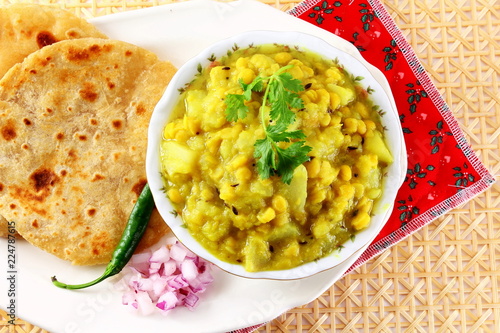 traditional indian gujarati  food dudhi chana curry shak stew recipe with roti or bhakhri or chapati photo