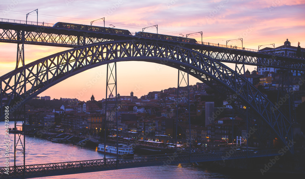 Obraz premium Beautiful super wide-angle summer aerial view of Porto, Portugal, with Douro river and famous view of Dom Luis I Bridge in Porto skyline and scenery beyond the old town, during the sunset