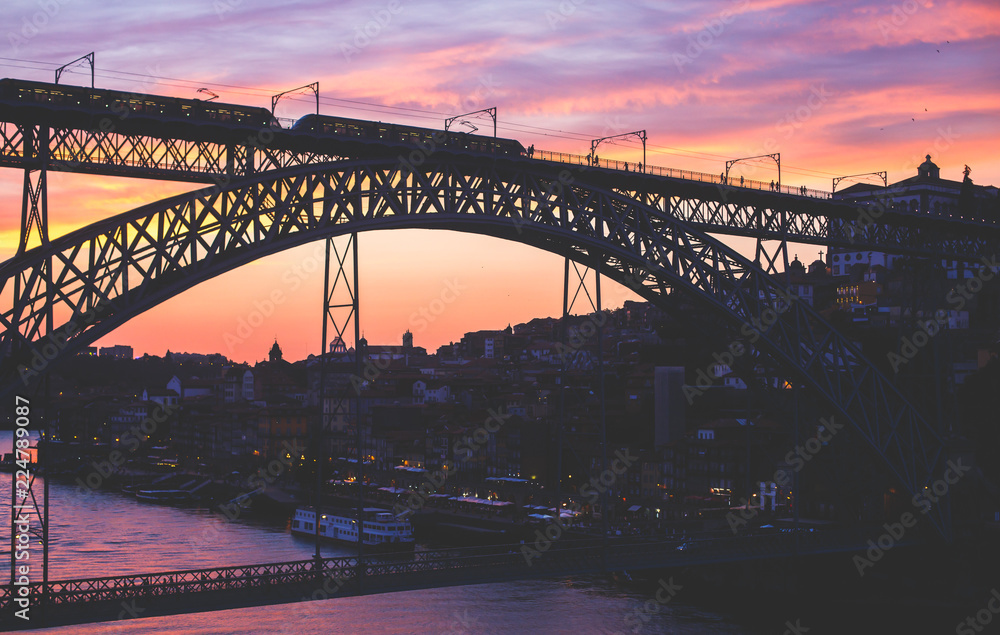 Obraz premium Beautiful super wide-angle summer aerial view of Porto, Portugal, with Douro river and famous view of Dom Luis I Bridge in Porto skyline and scenery beyond the old town, during the sunset
