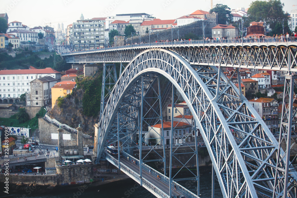 Fototapeta premium Beautiful super wide-angle summer aerial view of Porto, Portugal, with Douro river and famous view of Dom Luis I Bridge in Porto skyline and scenery beyond the old town, during the sunset