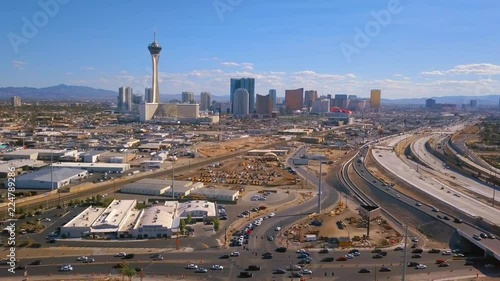 Aerial view of Las Vegas strip in Nevada, USA. View of the Stratosphere hotel and other popular buildings as well as highway and roads through the city.