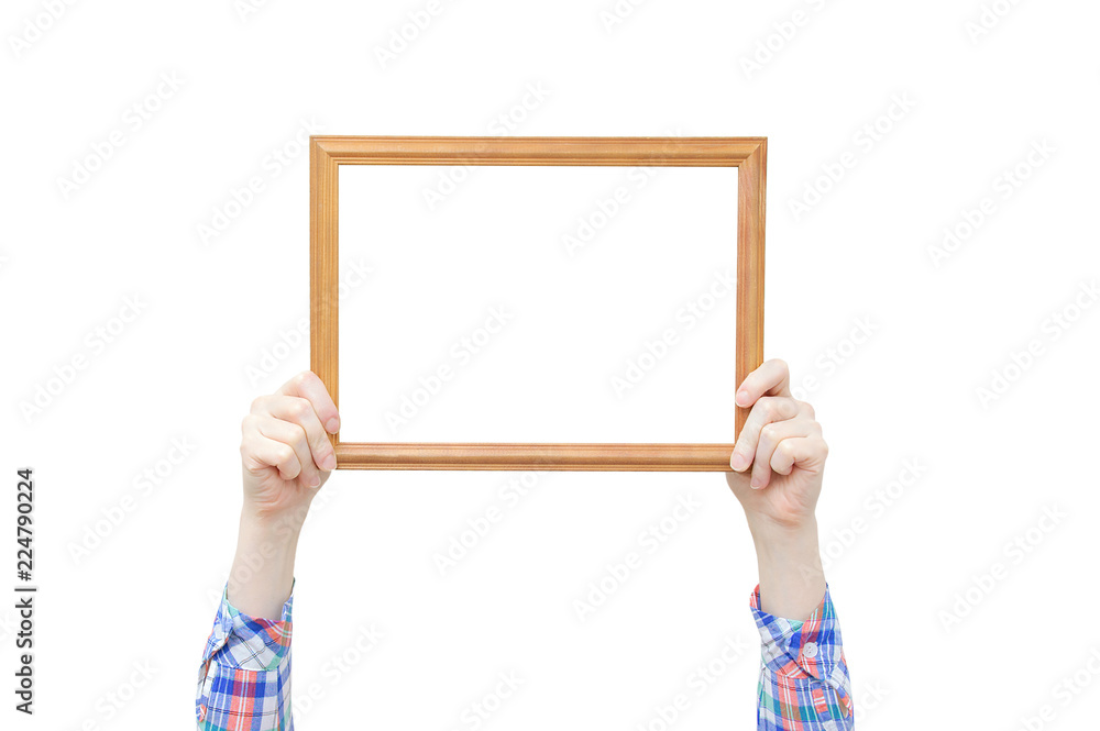 Wood frame for a photo in the hands of a girl. Close-up. White isolate. Wood frame for a photo in the hands of a girl. Close-up. White isolate.
