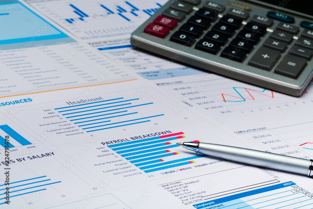 Pen and Calculator on Business Graphs and Charts Pen and Calculator on Business Graphs and Charts