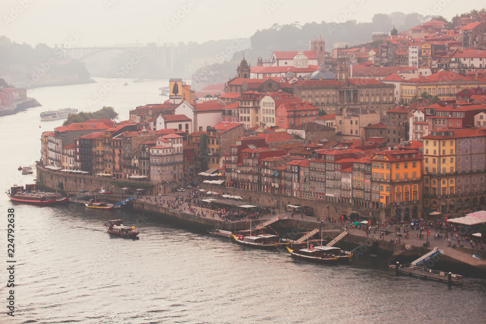 Naklejka premium Beautiful super wide-angle panoramic summer aerial view of Old Porto Oporto city and Ribeira Square with the old town, during the sunset over Douro river from Vila Nova de Gaia, Porto, Portugal