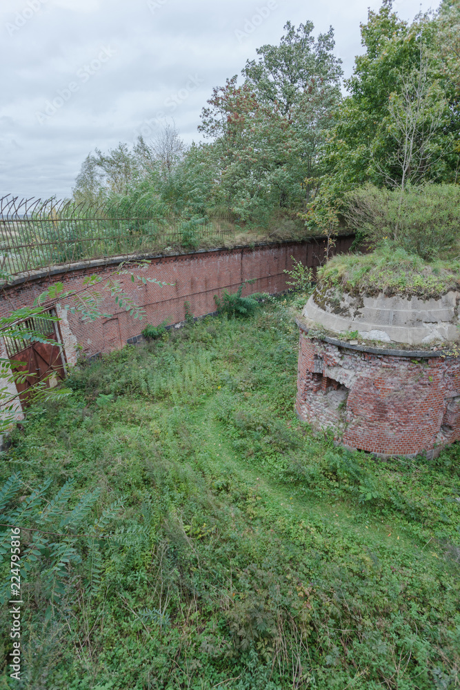 old German fortifications from red brick among the green forest